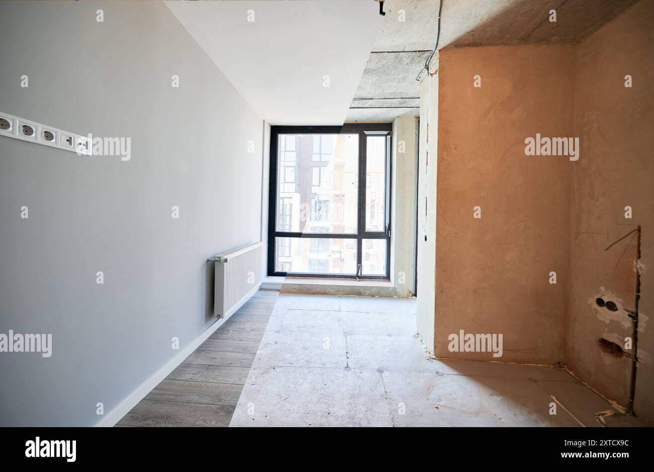 View of Comparison of living room with large panoramic window before and after ...
