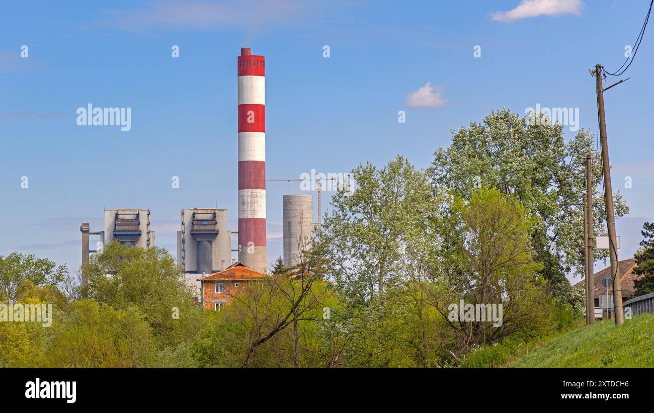 Red and White Chimney at Thermal Power Plant Facility Spring Day Blue Sky Stock Photo
