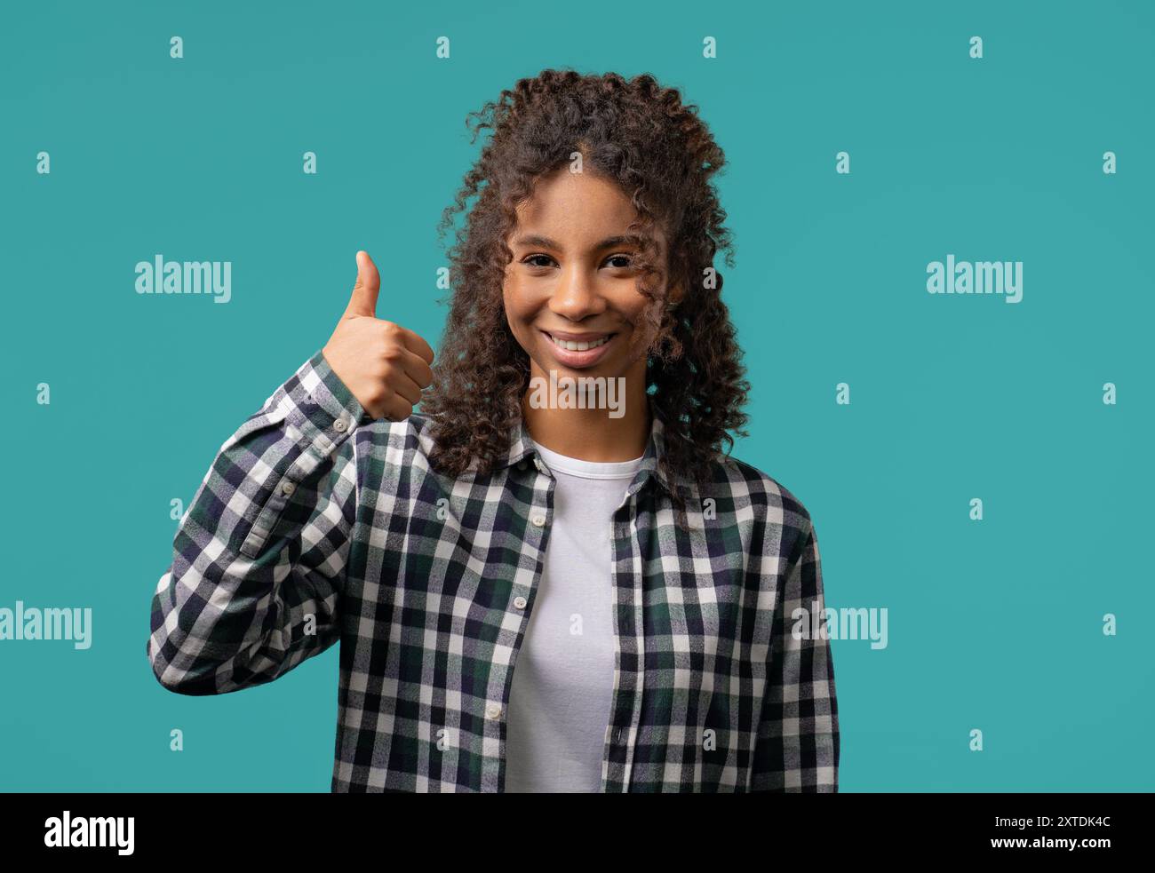 Positive teenager girl with hand sign like, thumbs up gesture. Woman on ...