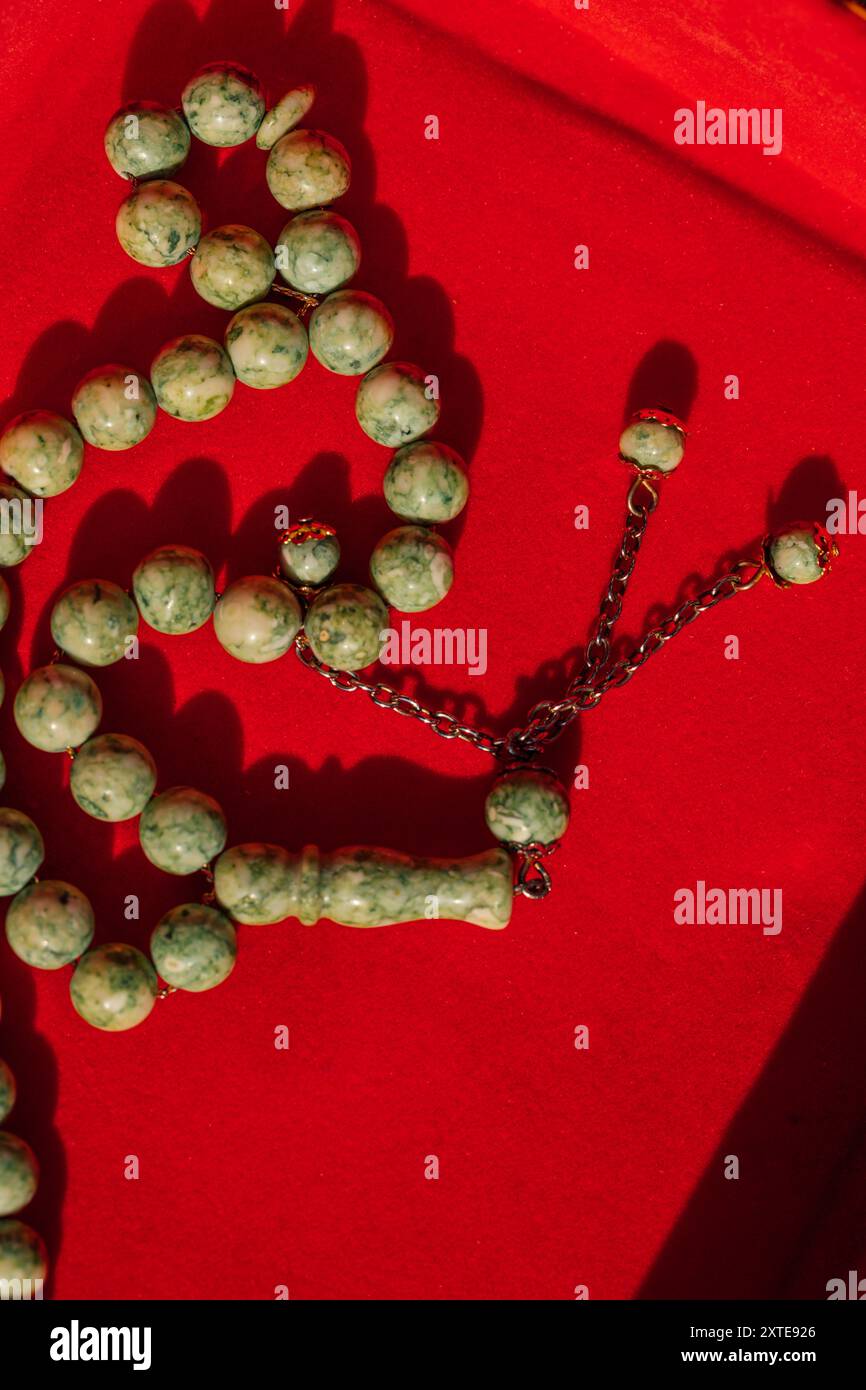 green stone Tasbih, islamic prayer beads in red velvet box Stock Photo