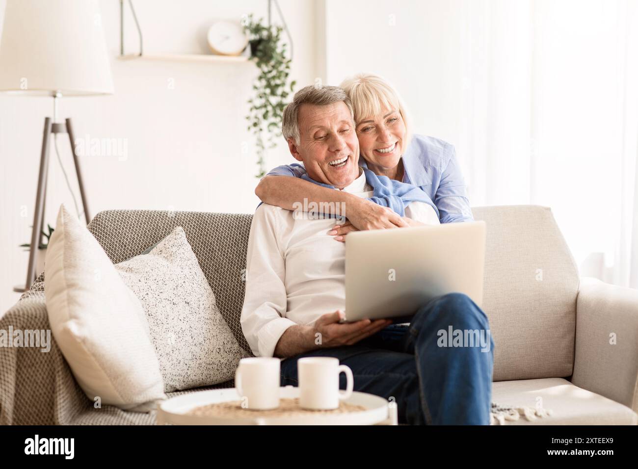 Happy senior couple having video call on laptop Stock Photo