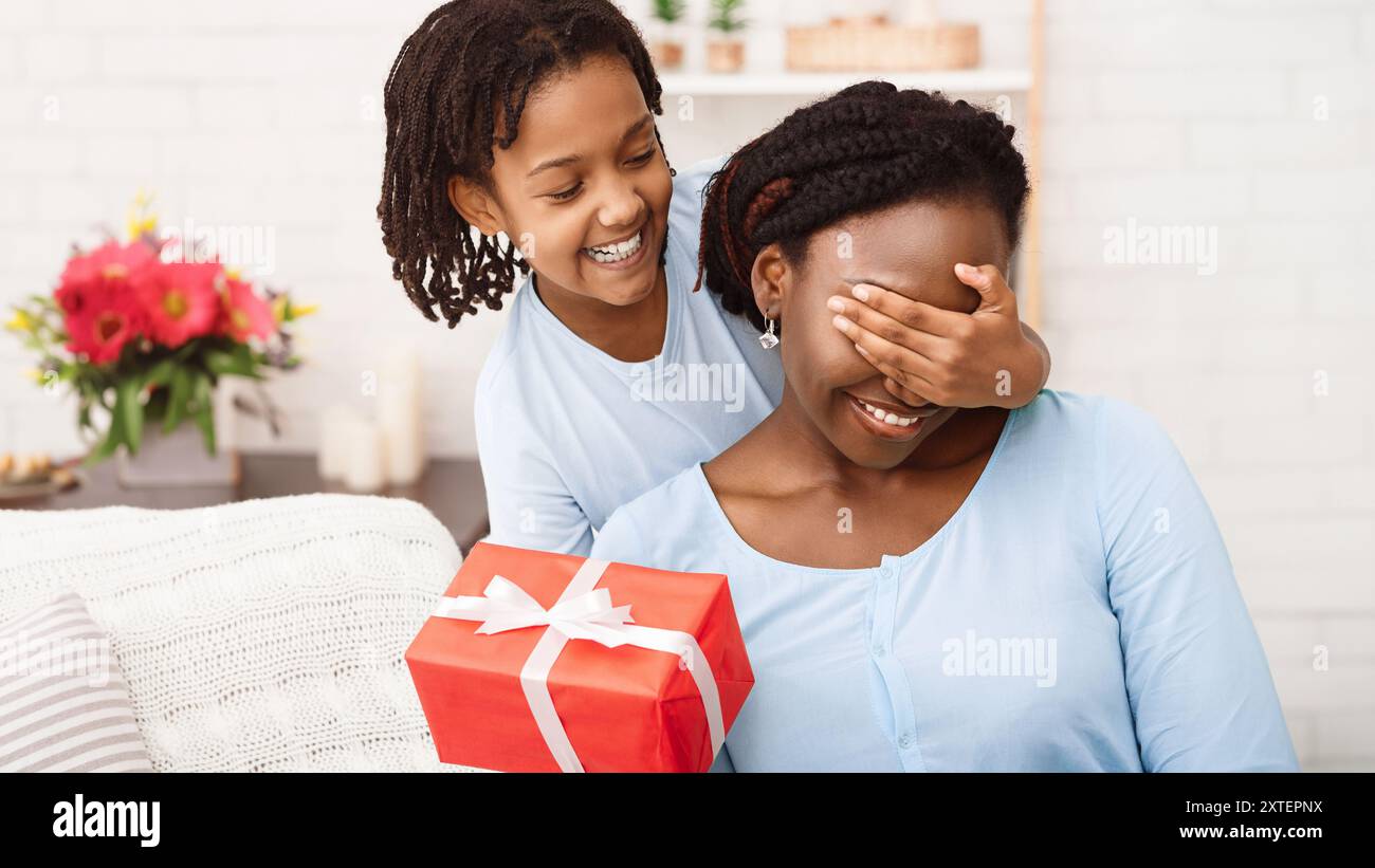Kid congratulating mom, making surprise at home Stock Photo Alamy — free download