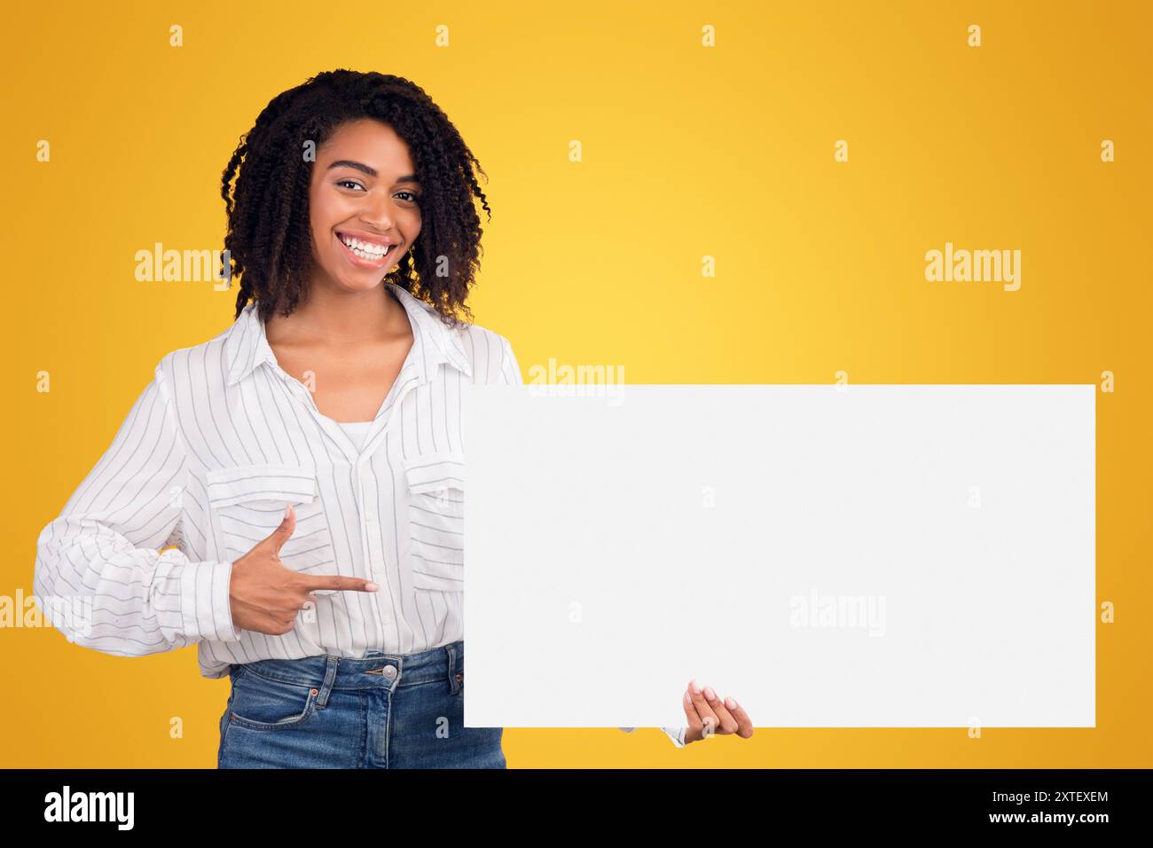 African american girl pointing at white paper Stock Photo - Alamy