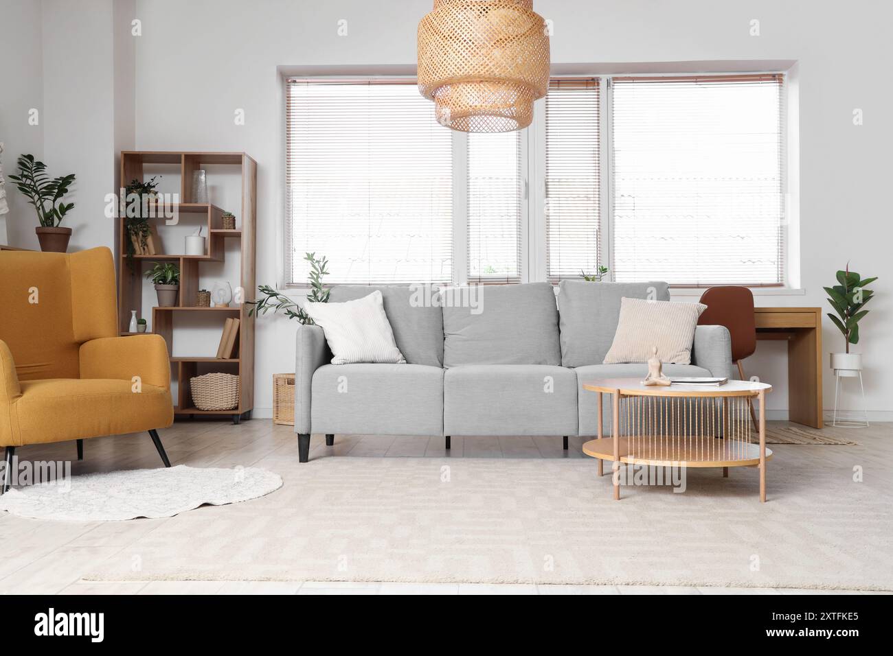 Interior of living room with grey sofa, table and window Stock Photo ...