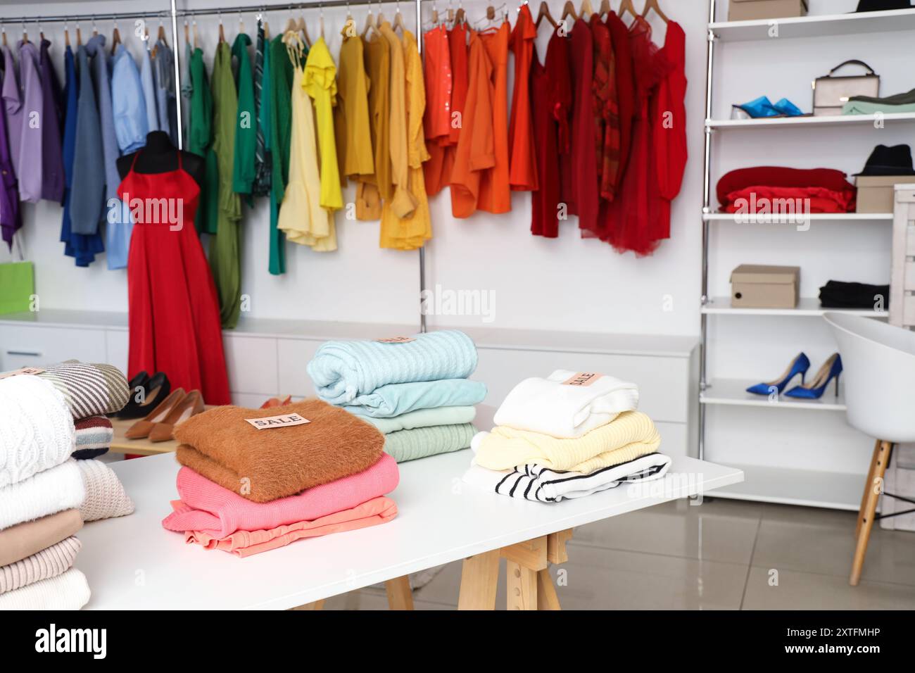 Folded clothes on table in boutique Stock Photo