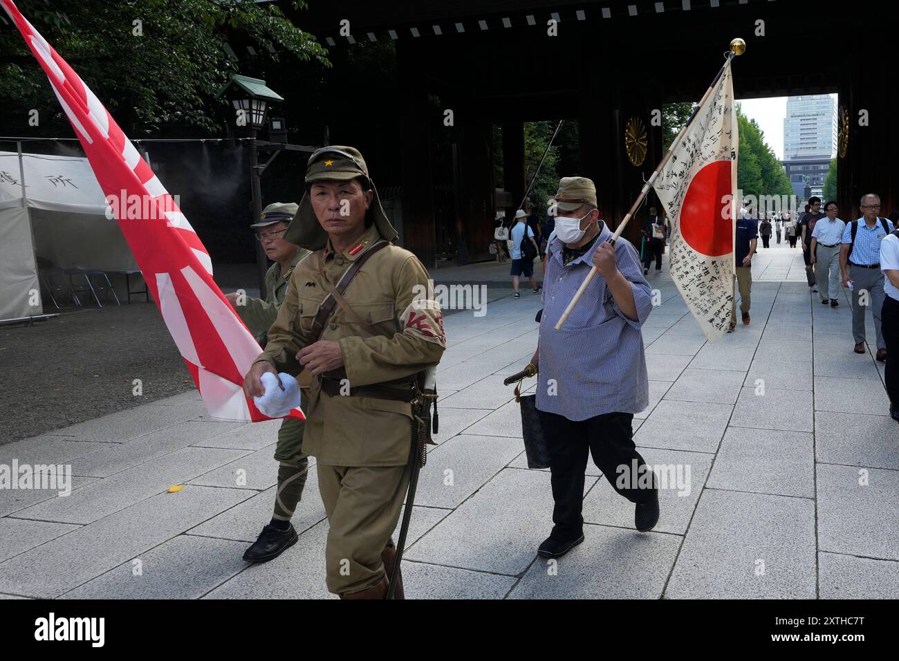 People clad in outdated military uniforms walk towards the main hall of ...
