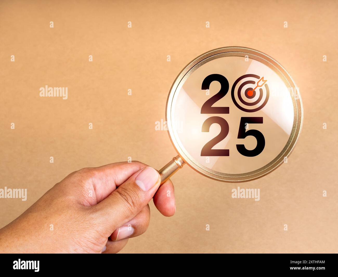 Happy new year 2025 with business trends and market concept. 2025 calendar  number with target icon in magnifying glass lens in people hand on light br  Stock Photo - Alamy