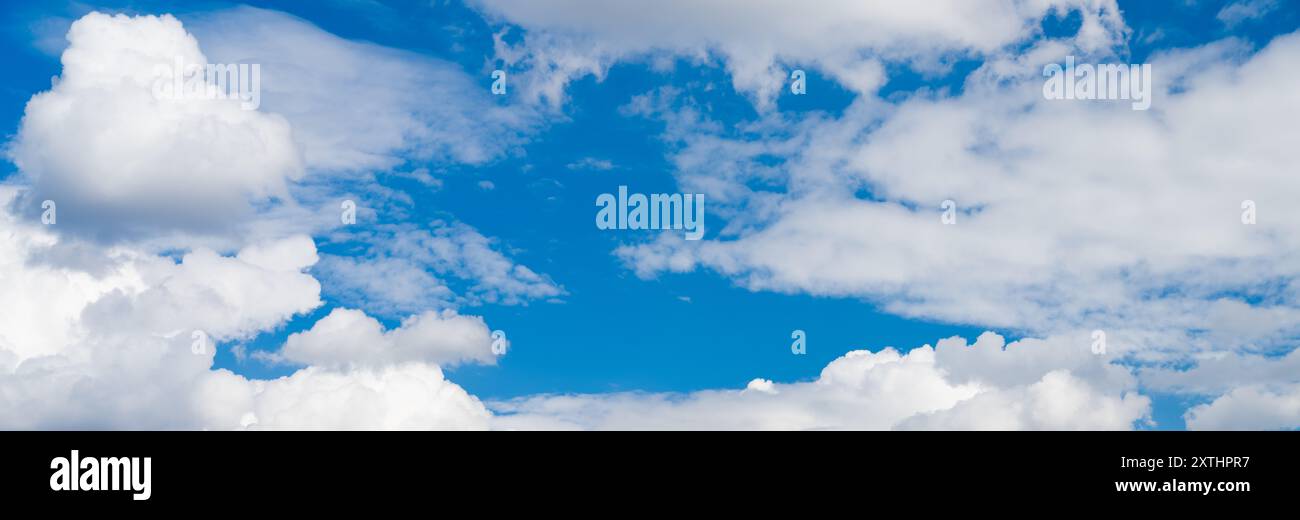 Blue sky between white clouds. Sky background texture Stock Photo