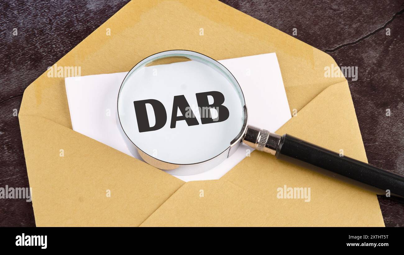 DAB Written through a magnifying glass on a piece of paper sticking out ...