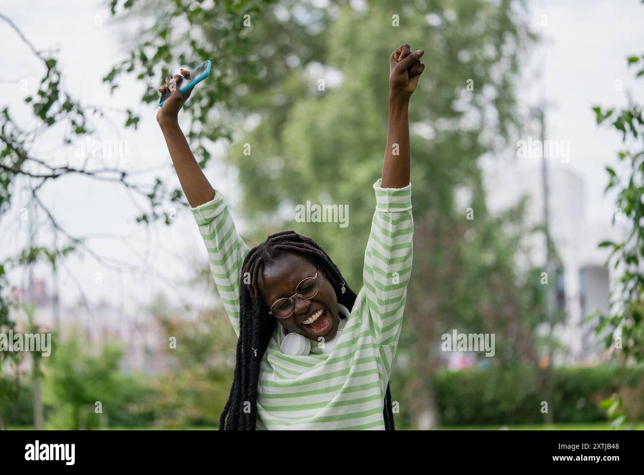 African american woman raises arms hi-res stock photography and images ...