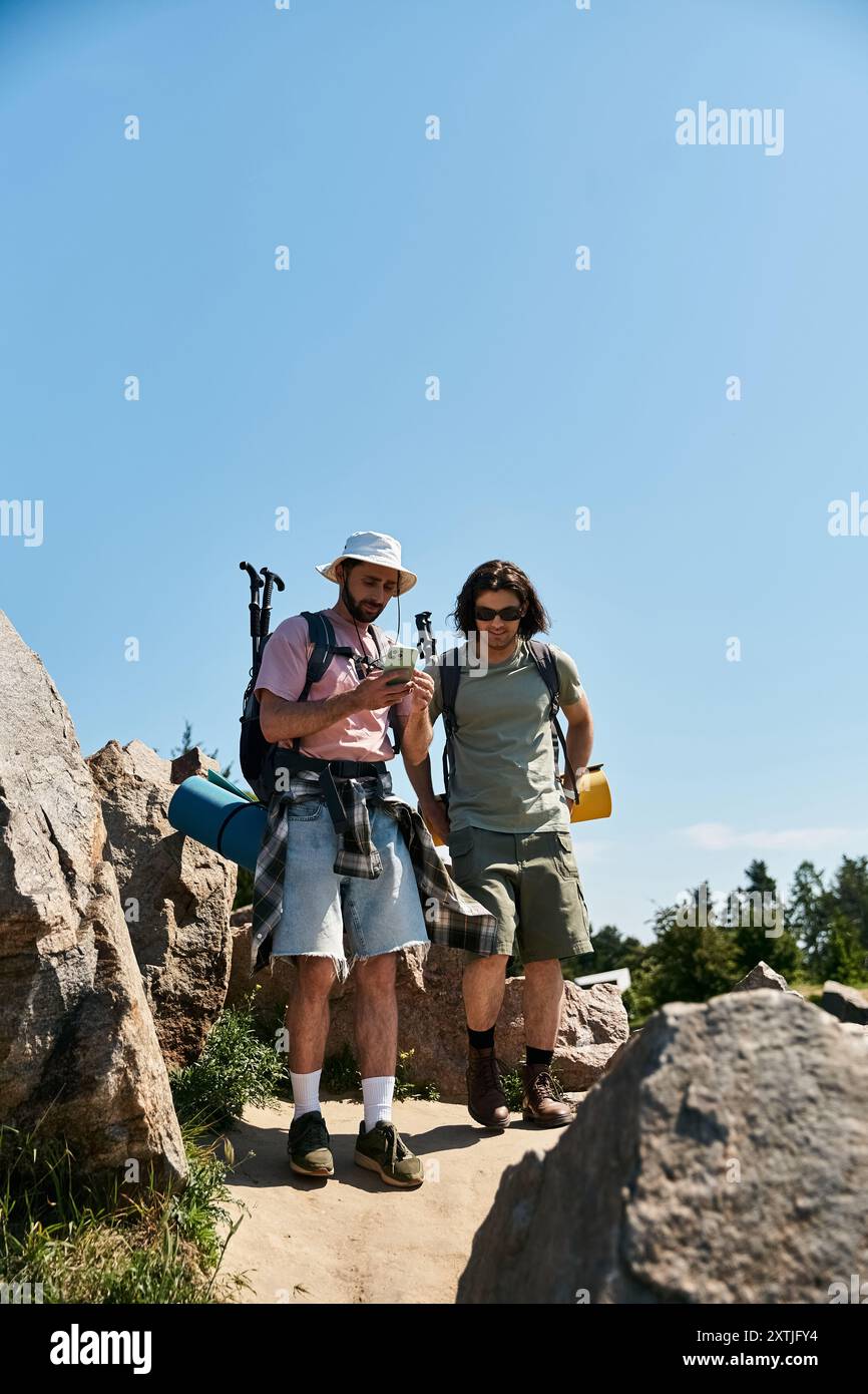 A gay couple enjoys a summer hike, navigating through rocky terrain and 