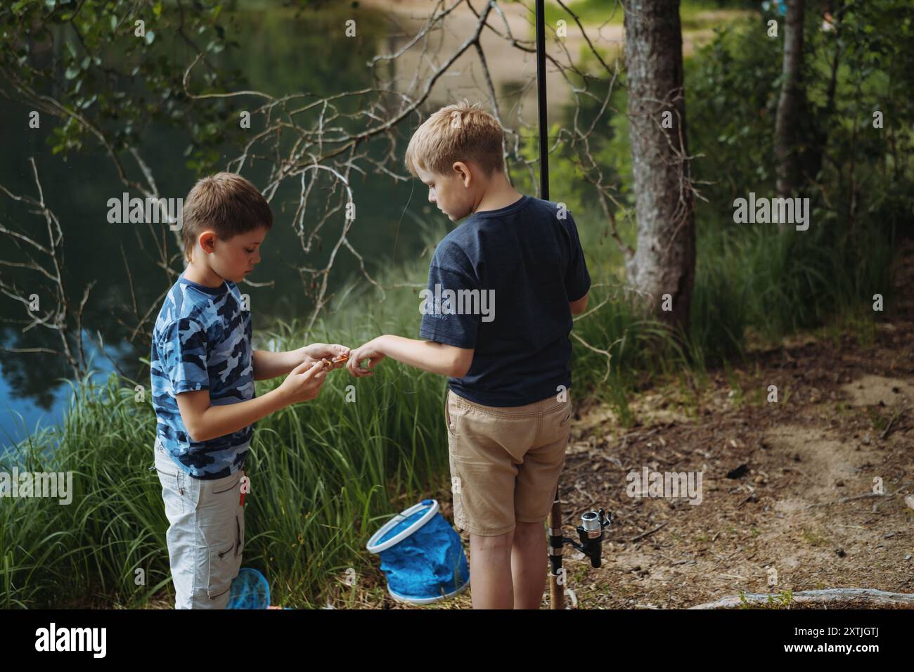 Two boys fishing in river hi-res stock photography and images - Alamy