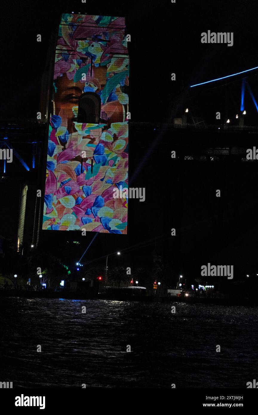 Sydney’s landmark of the Harbour Bridge pillars draped with Aboriginal art lit-up with coloured lazar lights as part of the annual Vivid Sydney festiv Stock Photo