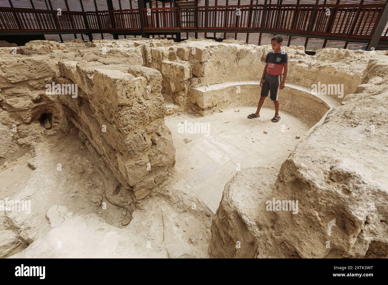 People stand on a platform overlooking ruins at the archaeological site of the Saint Hilarion Monastery in Tell Umm al-Amr People stand on a platform overlooking ruins at the archaeological site of the Saint Hilarion Monastery in Tell Umm al-Amr close to Deir al-Balah, in the central Gaza Strip on August 15, 2024. The Saint Hilarion complex, one of the oldest monasteries in the Middle East, has been put on the UNESCO list of World Heritage sites in danger due to the war in Gaza, the body said on July 26, 2024. UNESCO said the site, which dates back to the fourth century, had been put on the en Stock Photo