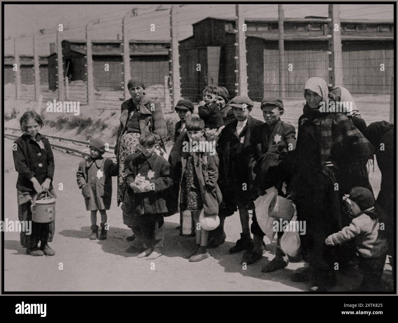 AUSCHWITZ DEATH CAMP WW2 Jewish women and children from Subcarpathian Rus who have been selected for death at Auschwitz-Birkenau, walk unwittingly toward the gas chambers. A stark reminder from history, of the shocking inhumanity of man. Photographer Bernhardt Walter/Ernst Hofmann Date May 1944 Auschwitz, [Upper Silesia] Poland Stock Photo