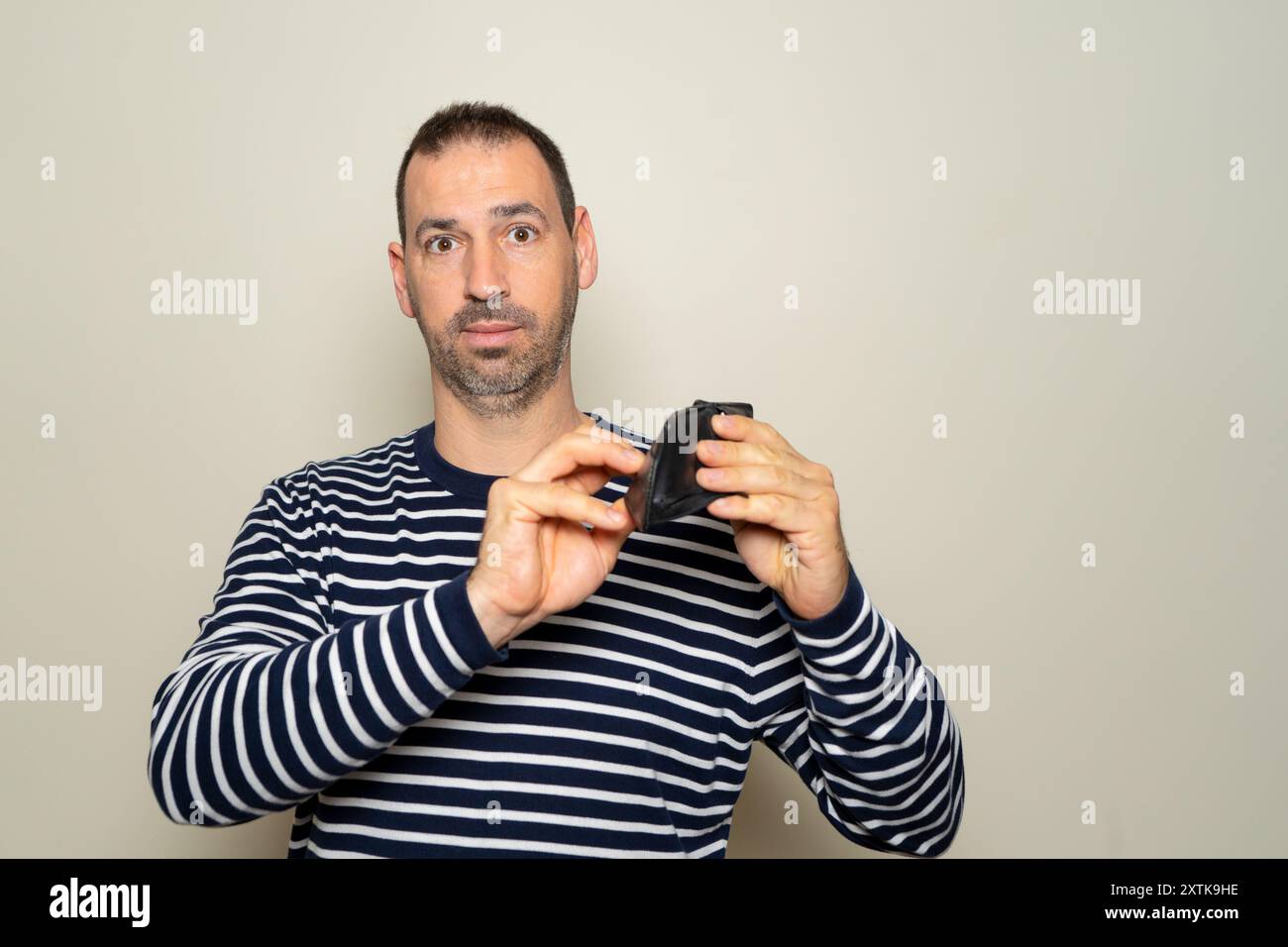 Bearded hispanic man in his 40s wearing a striped sweater searching for ...