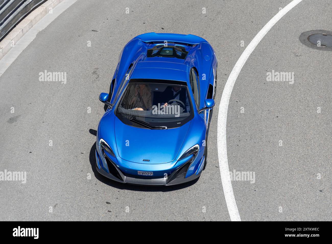 Monte Carlo, Monaco - View on a blue McLaren 675LT Spider driving on the road in the Fairmont Hairpin. Stock Photo