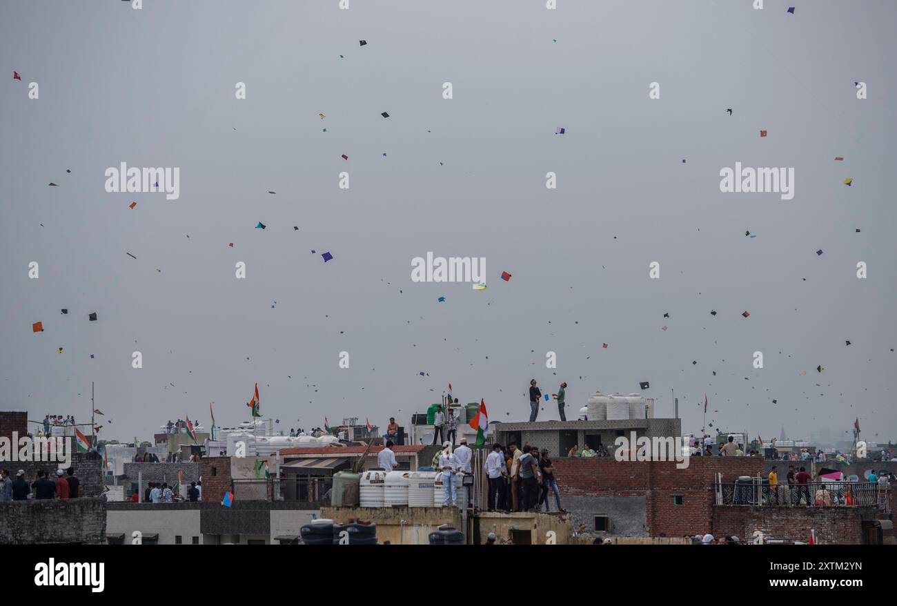 New Delhi, India. 15th Aug, 2024. People fly kites from the rooftops of ...