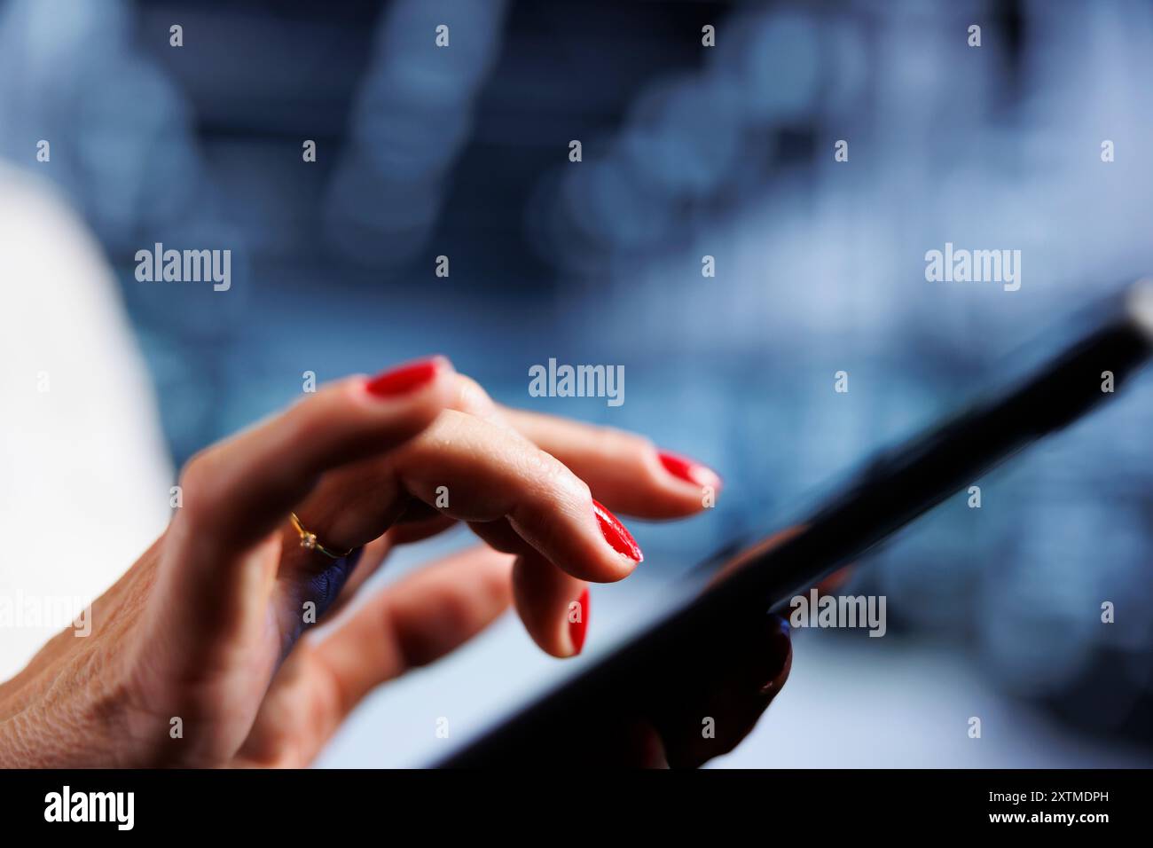 System administrator using tablet, ensuring valuable data remains shielded from potential security concerns, safeguarding server rackmounts against unauthorized access and vulnerabilities, close up Stock Photo