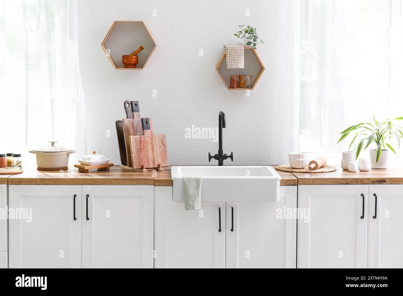 Interior of light modern kitchen with white counter Stock Photo - Alamy