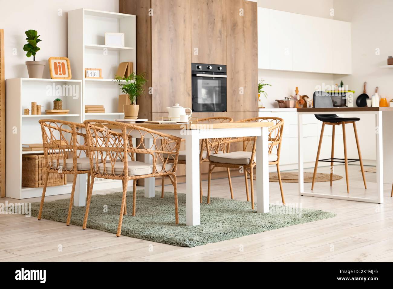 Interior of cozy kitchen with dining table and shelf units Stock Photo ...