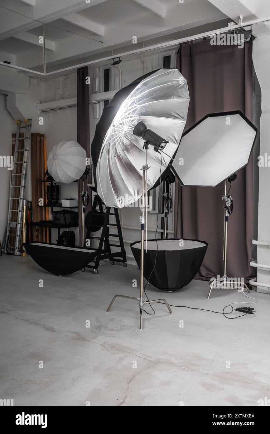 interior of bright space of photo studio with large white cyclorama with lighting equipment Stock Photo