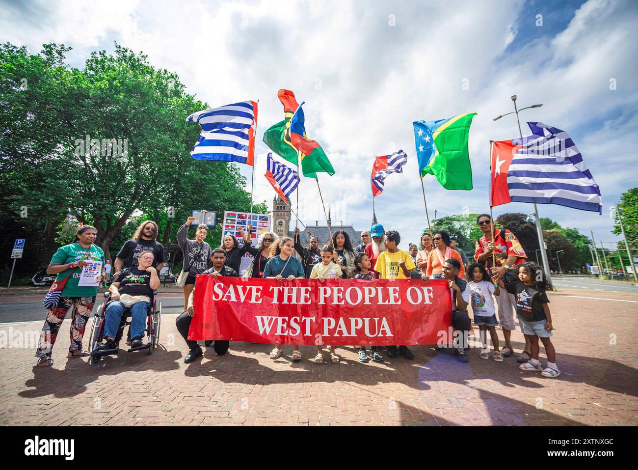 The Hague, Netherlands. 15th Aug, 2024. Protesters hold a banner and flags during the demonstration on the Carnegieplein, opposite International Court of Justice (ICJ). Indonesia invaded West Papua in 1961. Under great pollical pressure from the United States, West Papua was annexed by Indonesia in 1963. Since then, The West Papuan people have been fighting for their freedom and independence. End colonialism in the Pacific Ocean. Credit: SOPA Images Limited/Alamy Live News Stock Photo