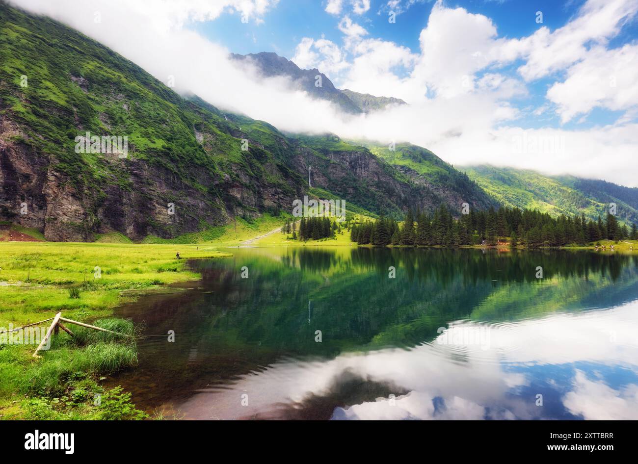 Beautiful summer lake landscape with mountain in the Autria Alps. Wonderful hiking spot. Alpine lake with high mountains. Pine trees. Hohe Tauern near Stock Photo