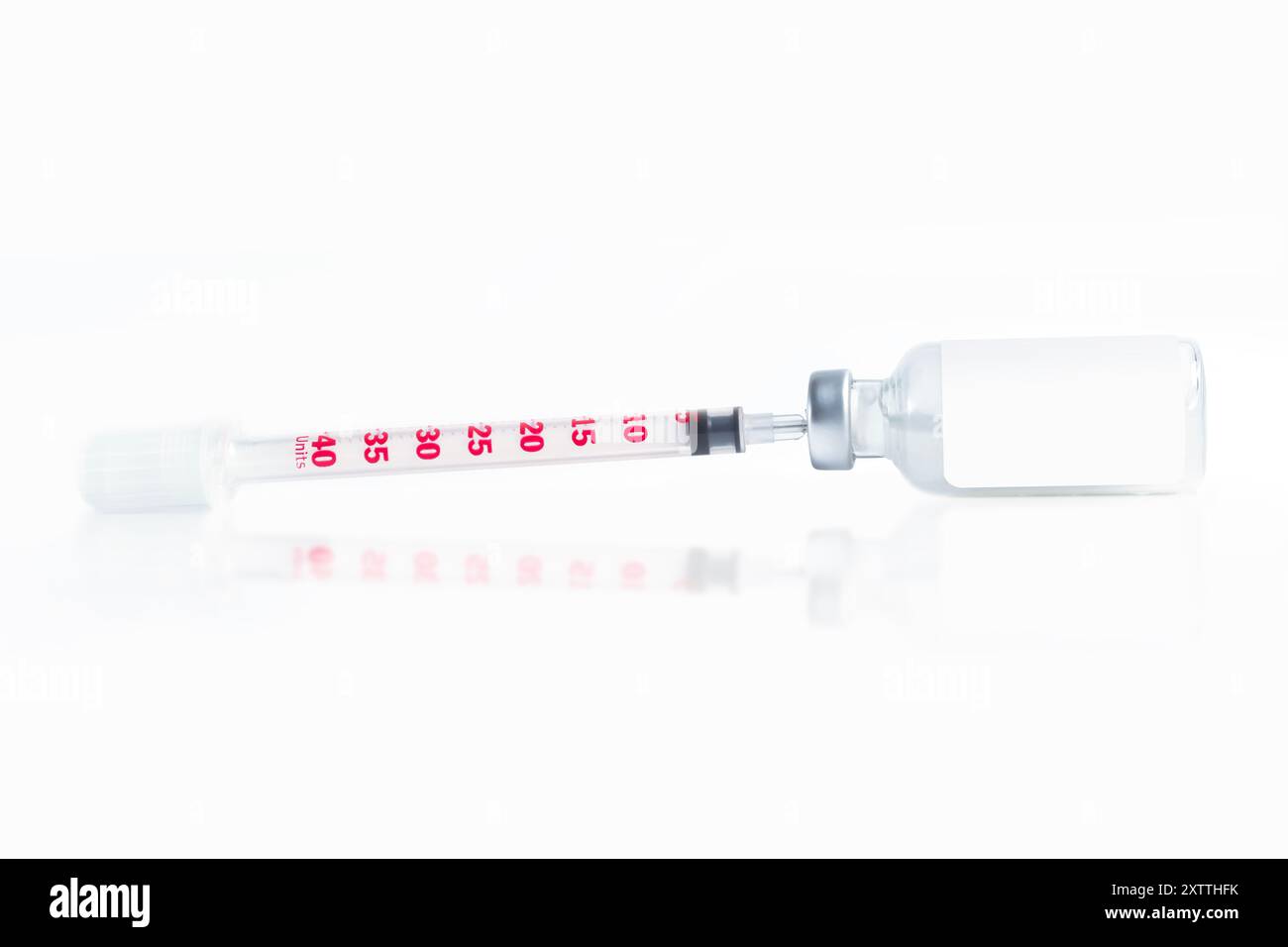 Medical syringe and vaccine vial isolated on a white background with ...