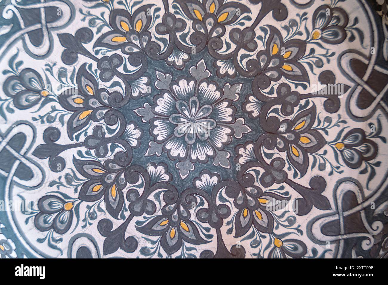 A patterned rug with a flower design Stock Photo