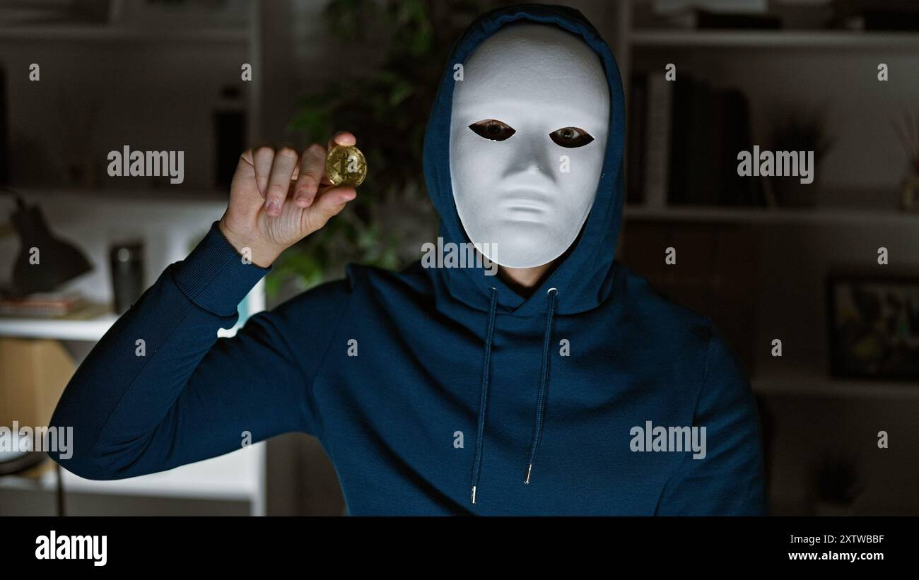 An anonymous person in a mask holds a bitcoin, conceptually linking  cryptocurrency to secrecy and privacy in an indoor setting Stock Photo -  Alamy