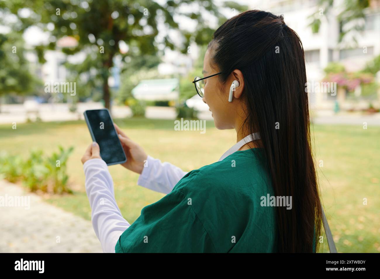 Asian lady using mobile device hi-res stock photography and images - Alamy
