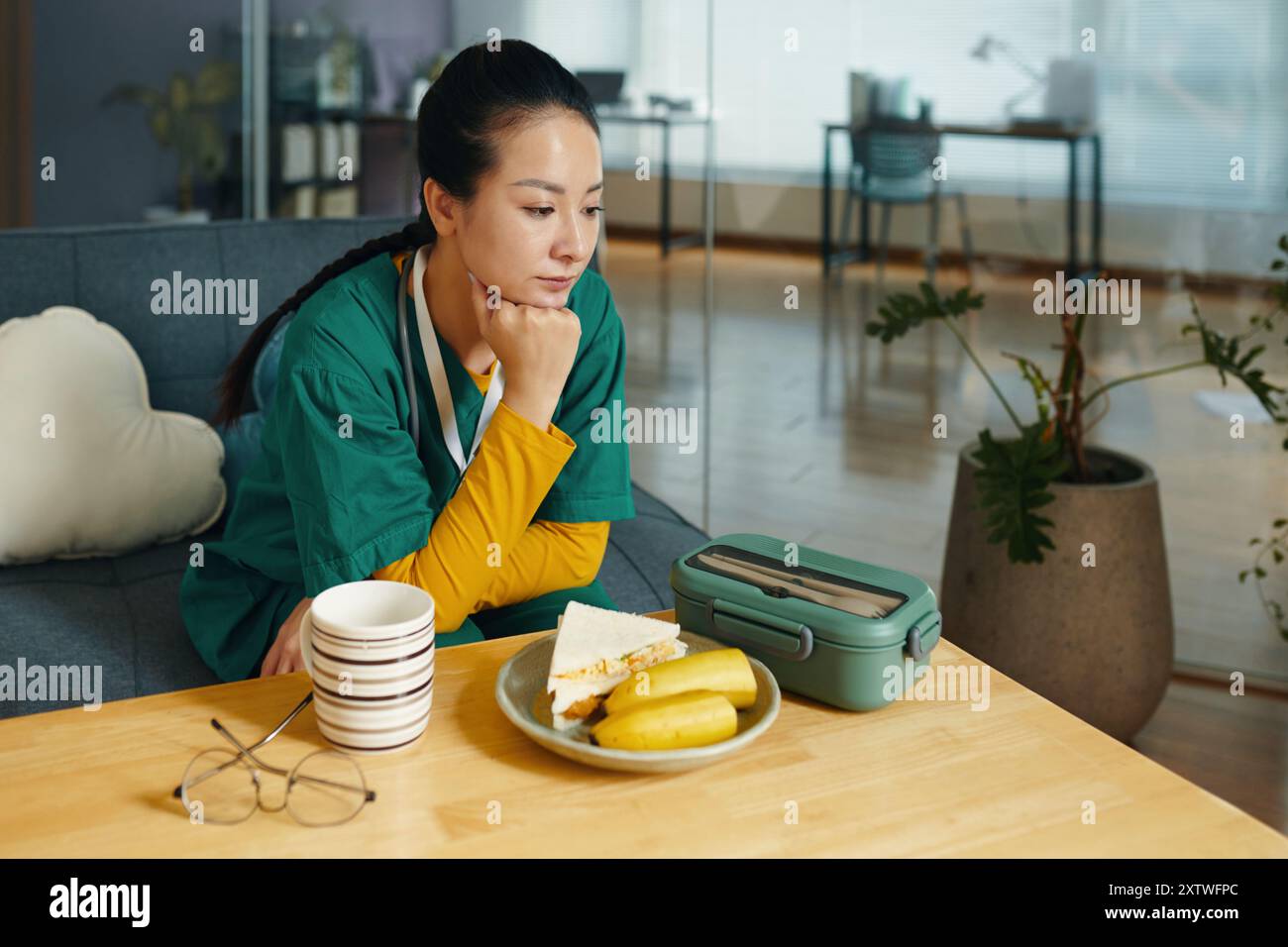 Reflecting While Taking Lunch Break in Cozy Living Room Stock Photo
