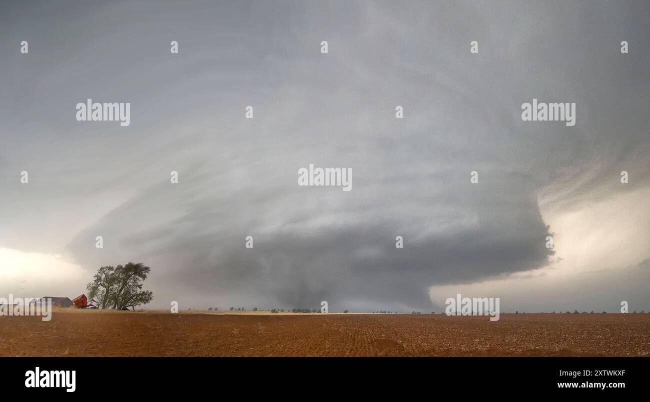 Expansive view of a dramatic storm cloud formation with tornado over a ...