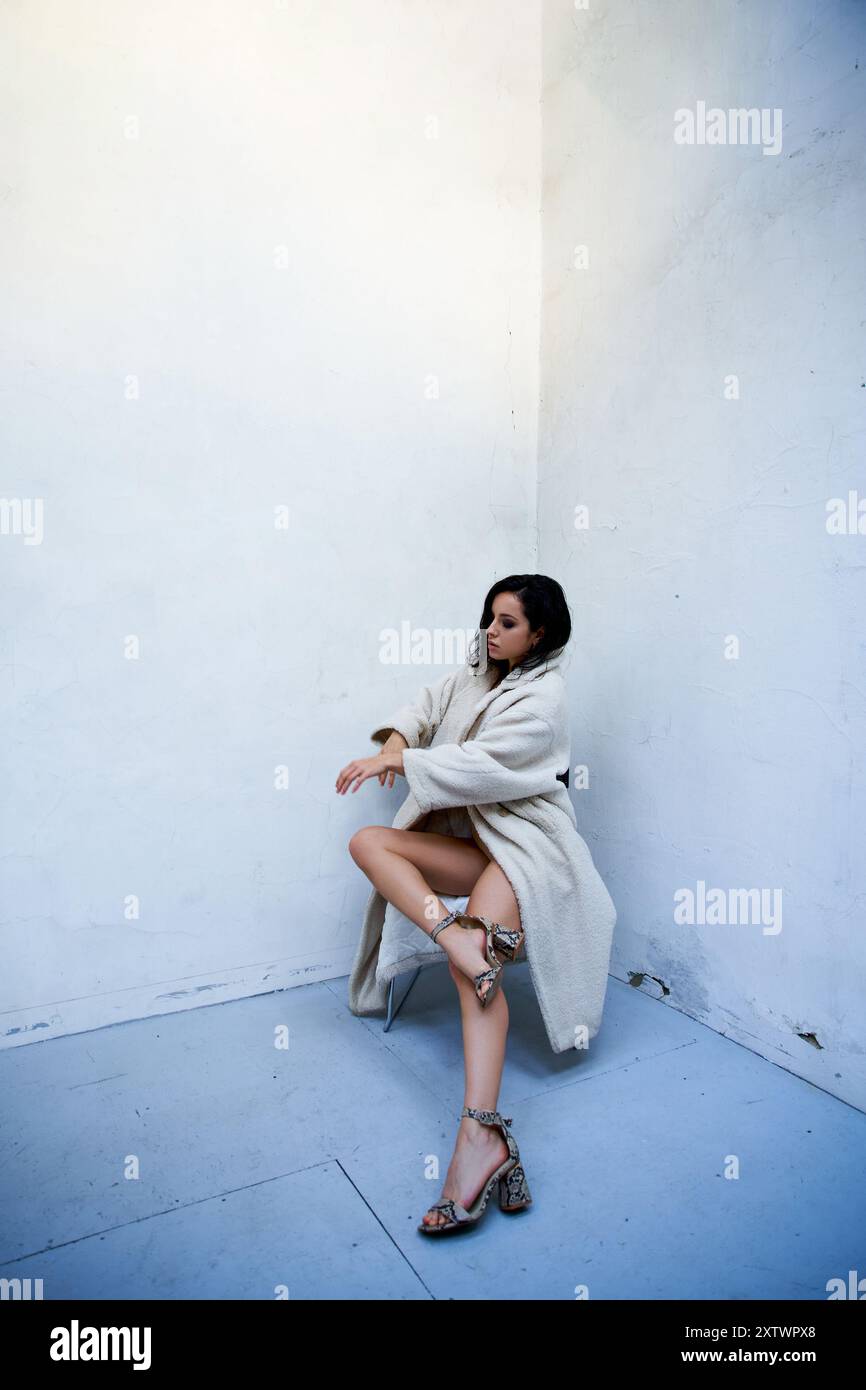 Brunette sitting on chair poses hi-res stock photography and images - Alamy
