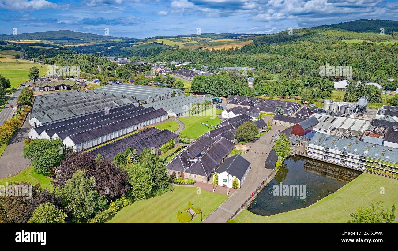 Glenfiddich distillery Moray Scotland blue summer sky over the distillery buildings many warehouses and the lake Stock Photo