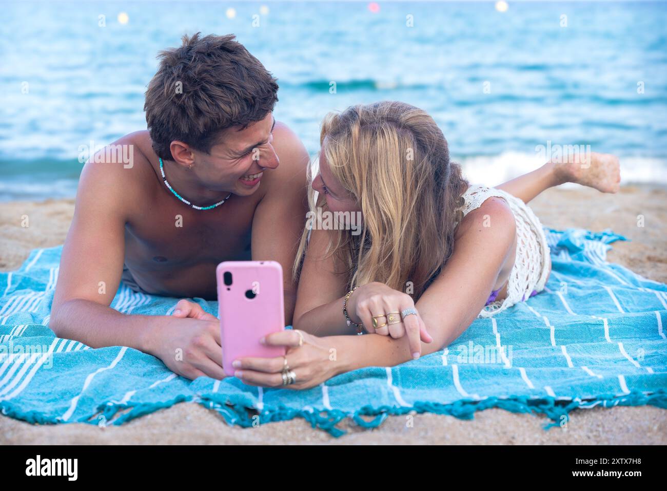 Young couple using smartphone app outdoors. Stock Photo