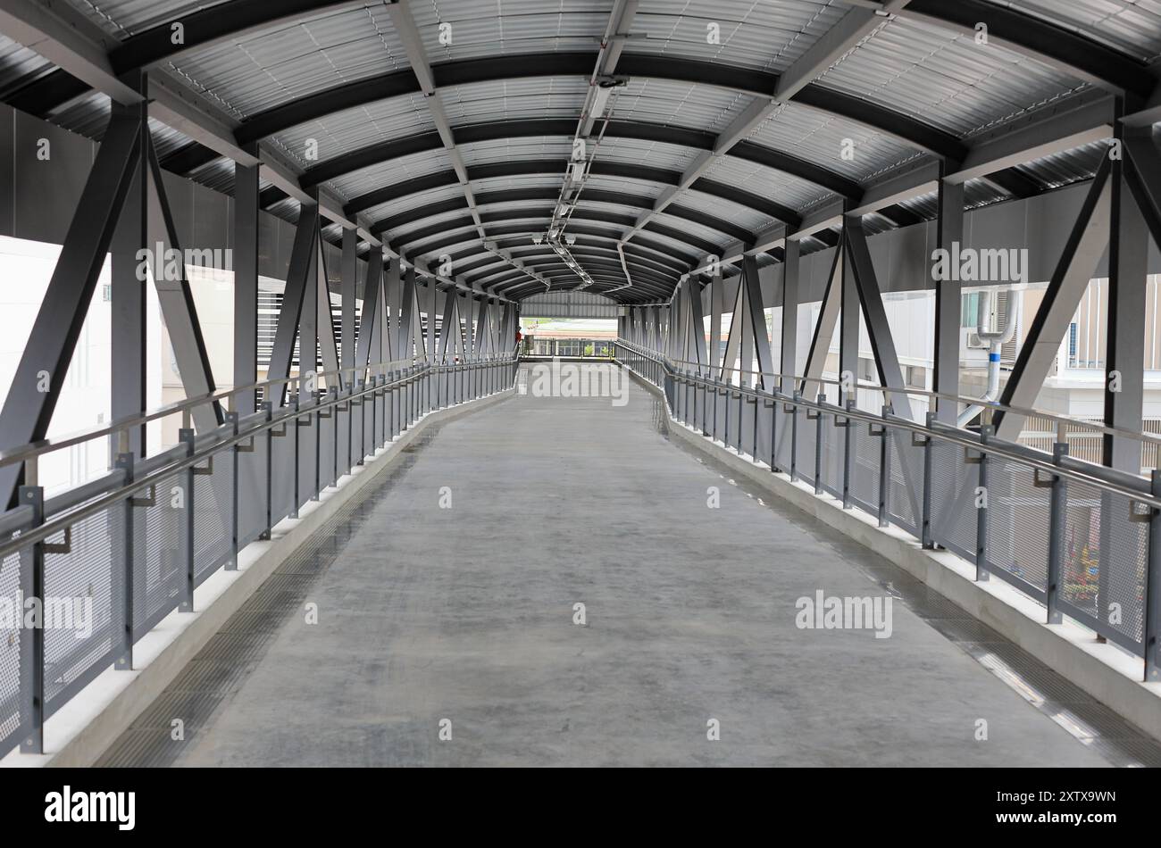 Pedestrian pathway or corridor or hallway between train station and other building. Stock Photo