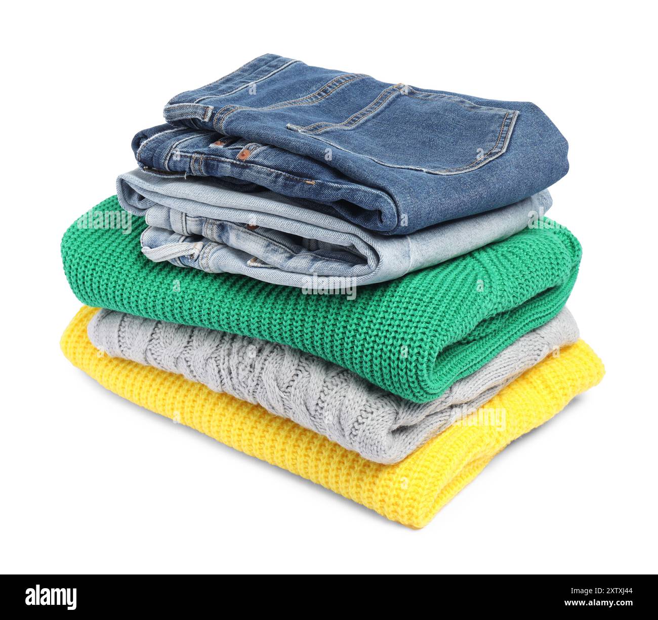 Stack of sweaters and jeans isolated on white Stock Photo
