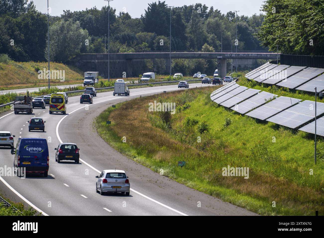 A58 motorway, photovoltaic systems were installed on the slopes to the side of the carriageway, use of the areas along the roads as a solar park, near Stock Photo