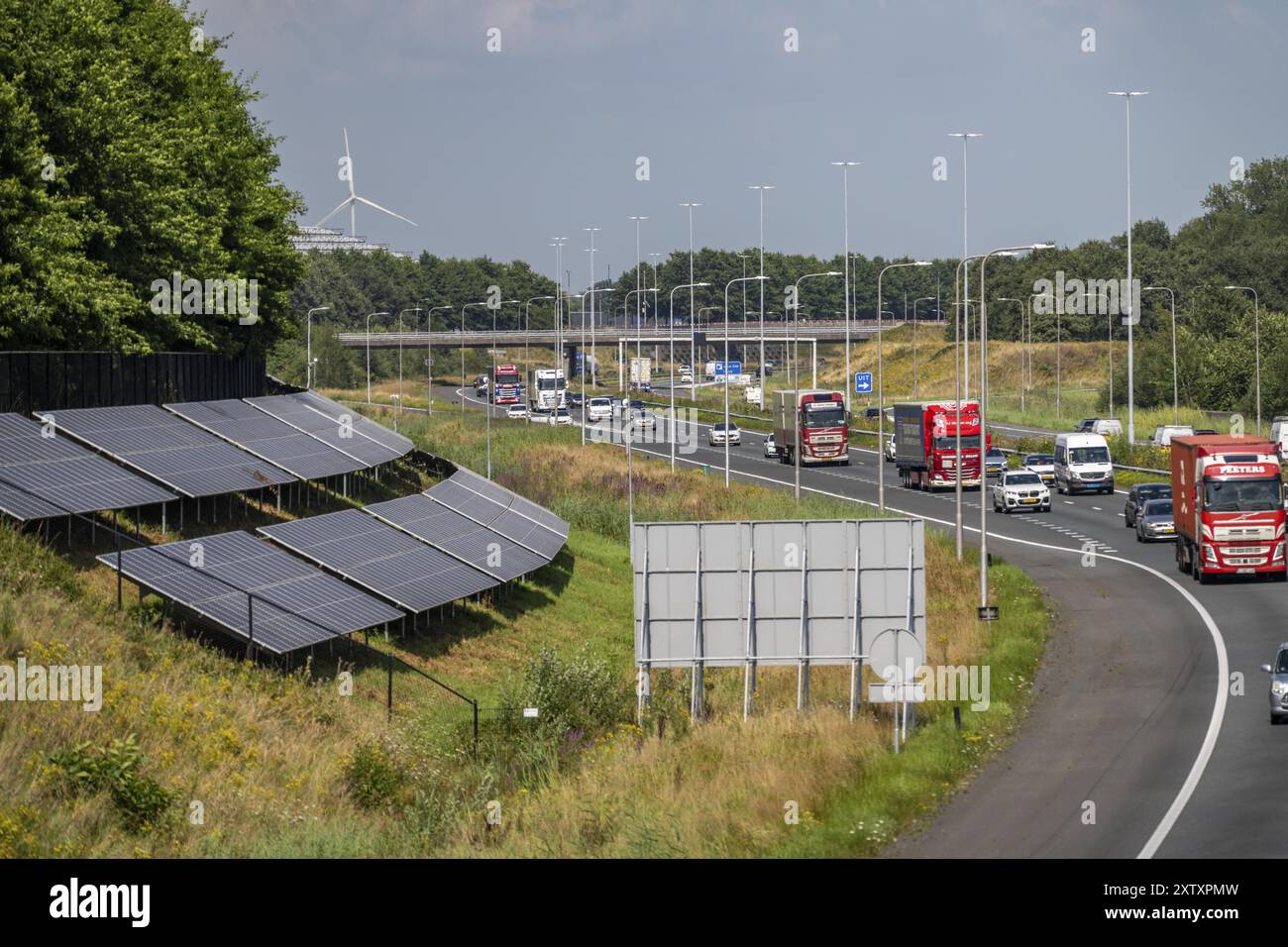 A58 motorway, photovoltaic systems were installed on the slopes to the side of the carriageway, use of the areas along the roads as a solar park, near Stock Photo