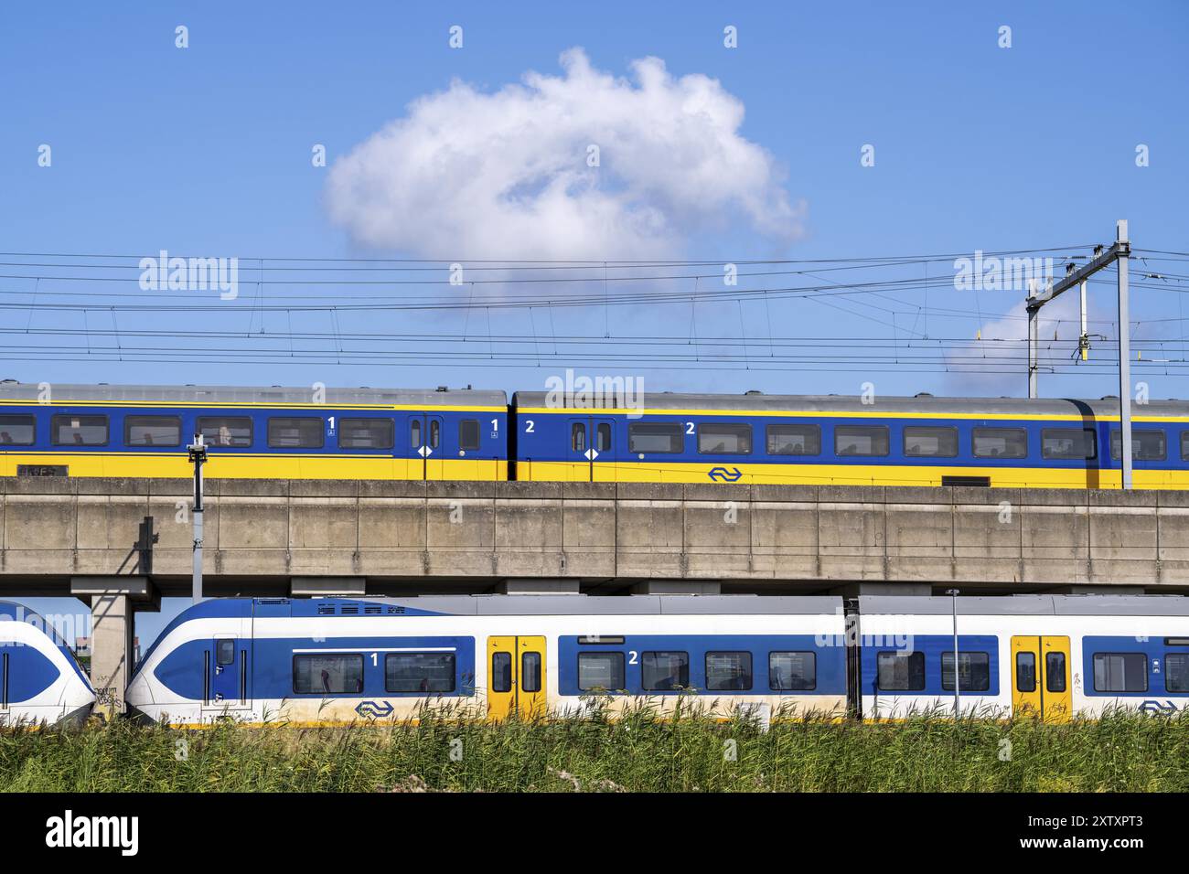 Trains of the Dutch railway, NS, Nederlandse Spoorwegen N.V., on a double-decker track, below local train Sprinter Light Train, above Intercity Direct Stock Photo