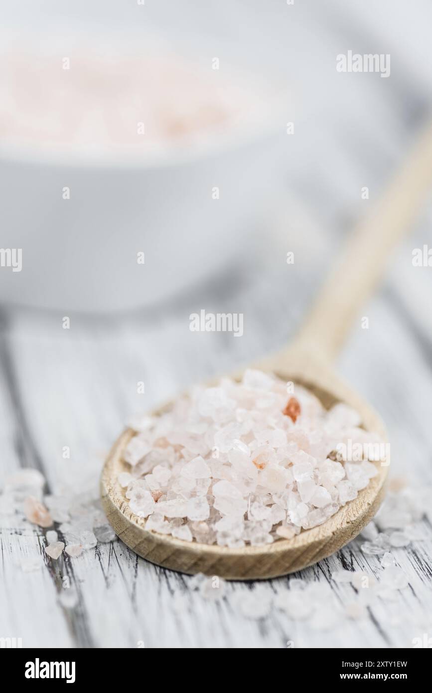 Salt (pink) on an old wooden table as detailed close-up shot (selective focus) Stock Photo
