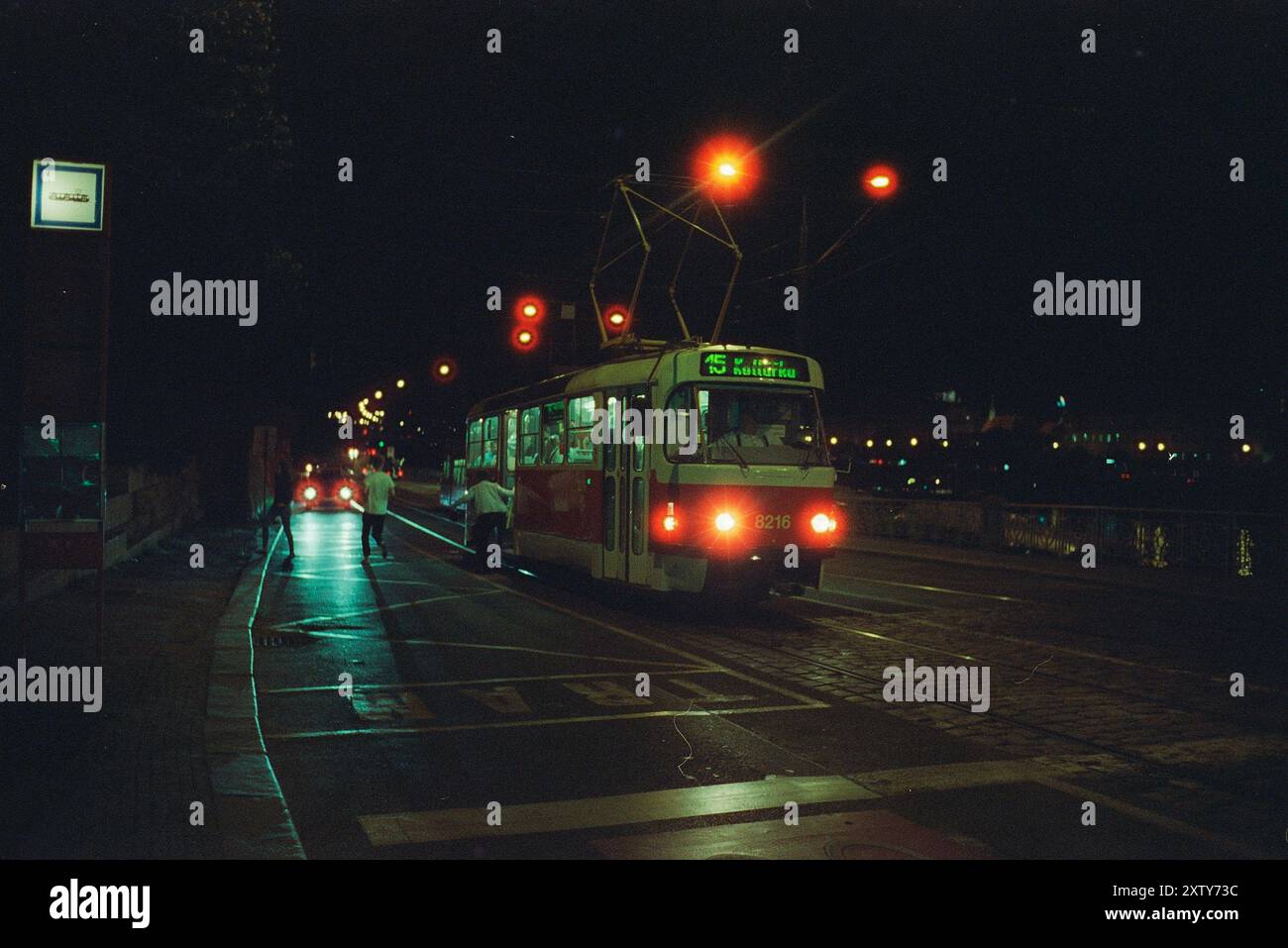 A night tram driving through a city shot on film Stock Photo