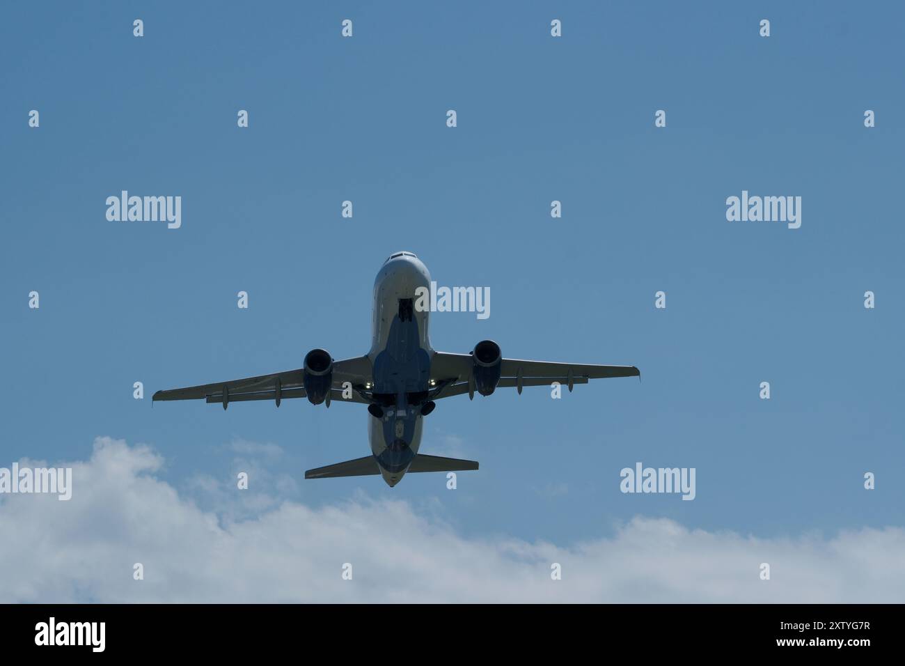 Airplane flying in the blue sky with white clouds on the background ...