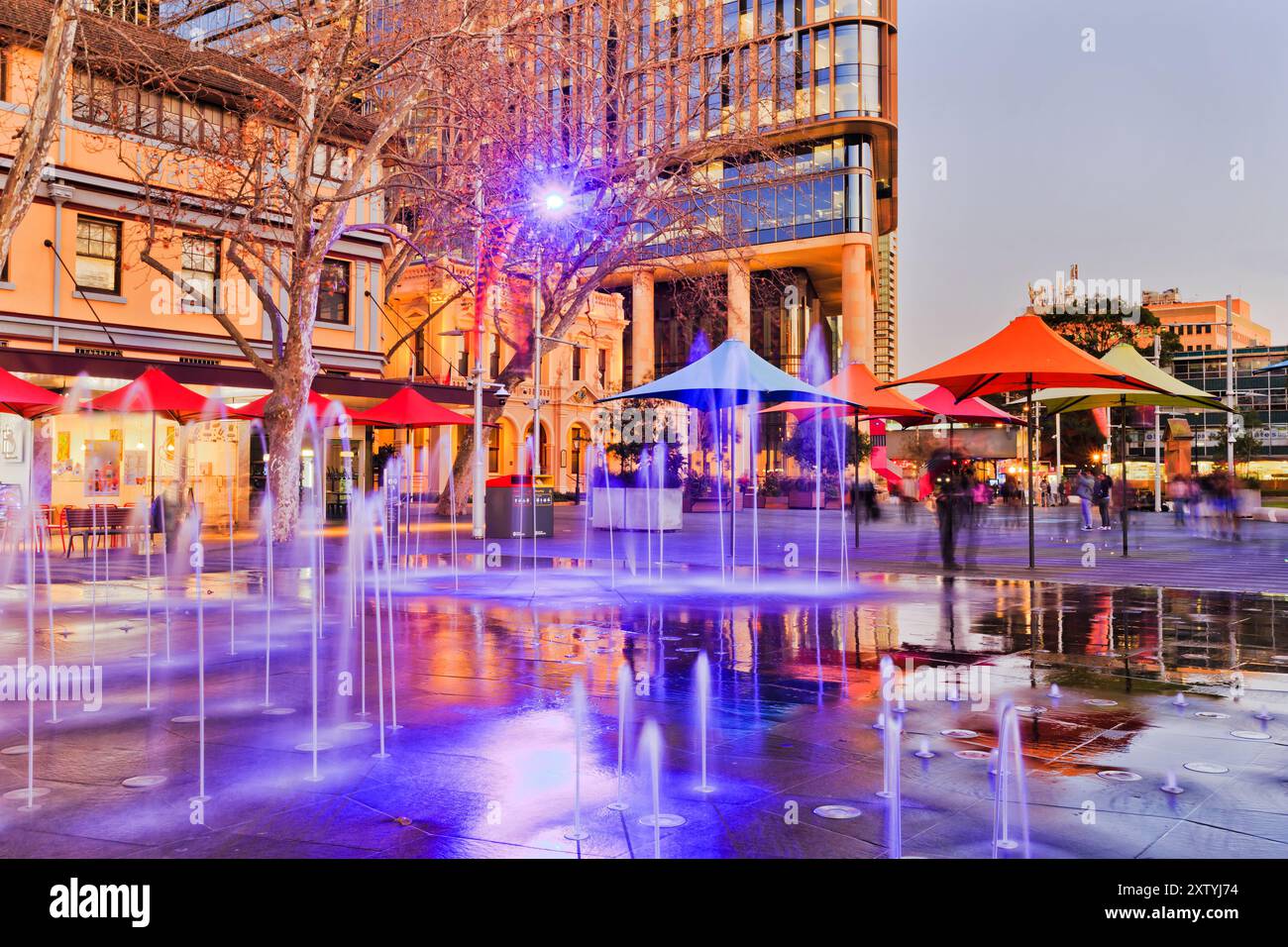 Sunset public square in the city of Parramatta with light fountains surrounded by cafes and city town hall. Stock Photo