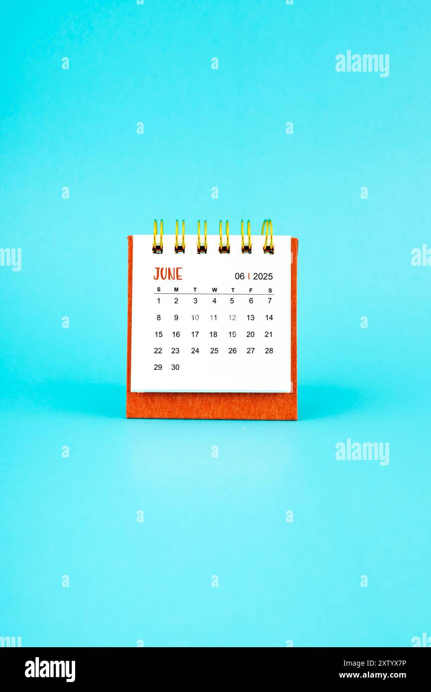 june-2025-white-desk-calendar-on-blue-color-background-stock-photo-alamy