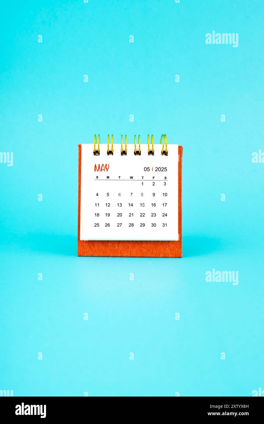 may-2025-white-desk-calendar-on-blue-color-background-stock-photo-alamy