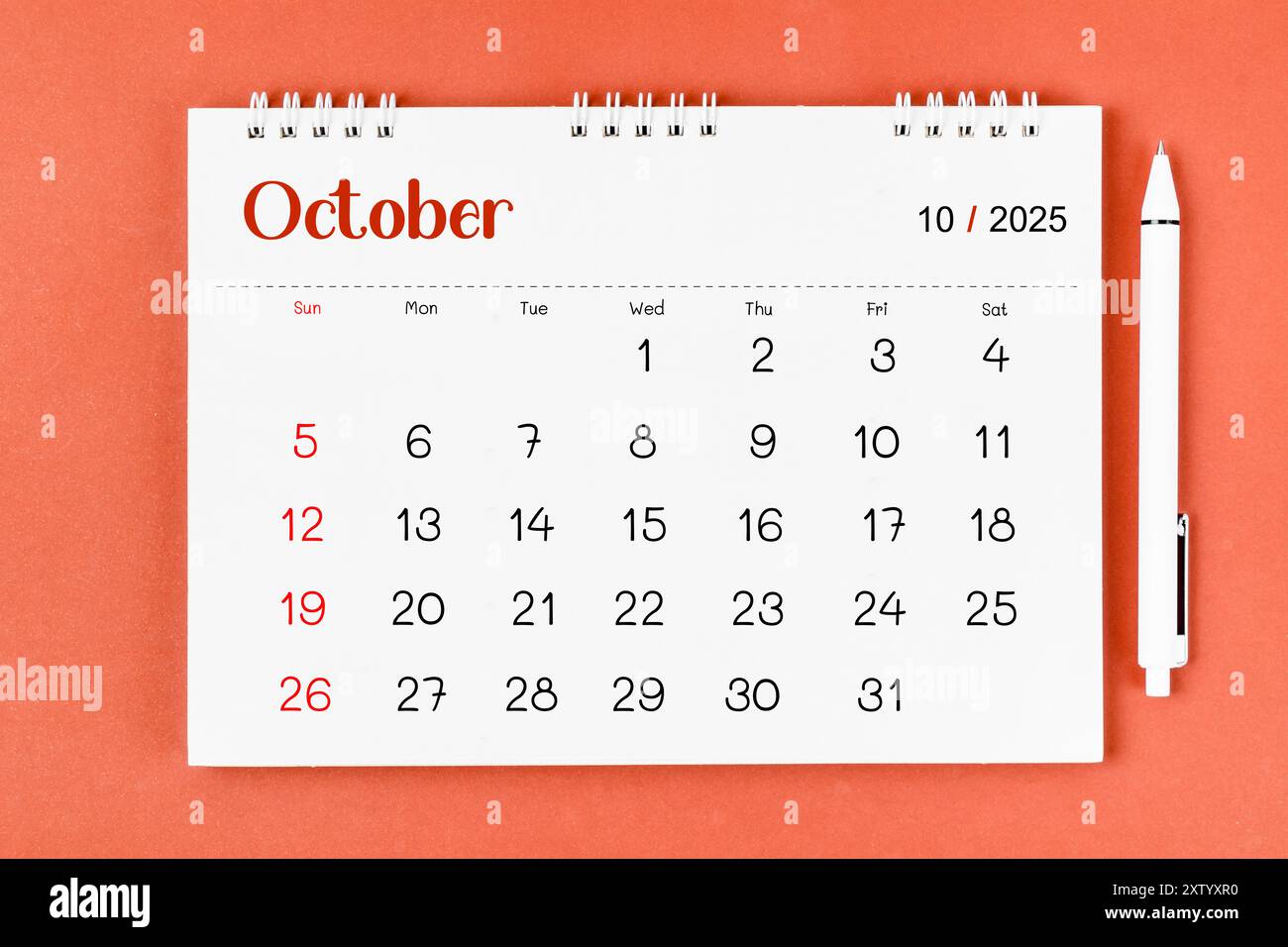 october-2025-monthly-desk-calendar-for-2025-year-and-pen-on-red-background-stock-photo-alamy