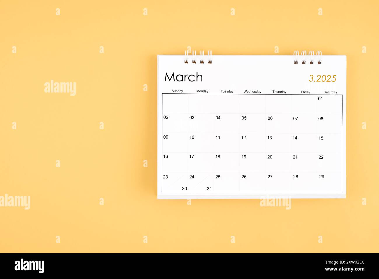 March 2025 desk calendar on yellow color background, position with copy